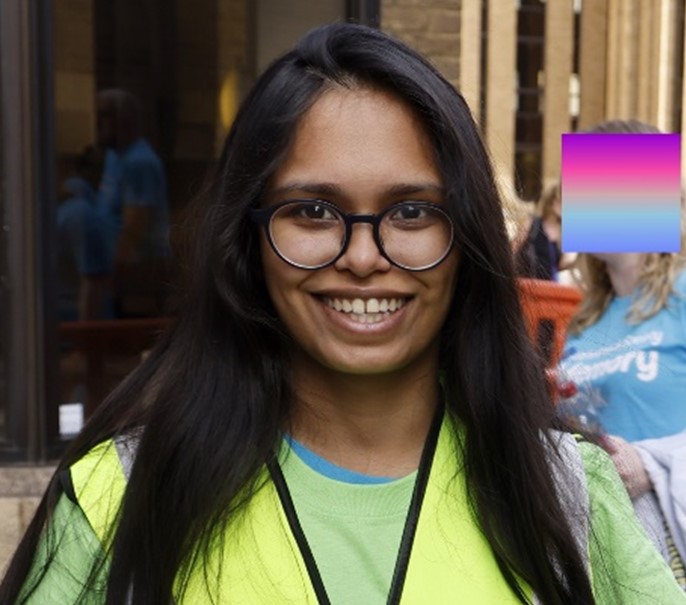 A smiling young woman at an Alzheimer's Society event.