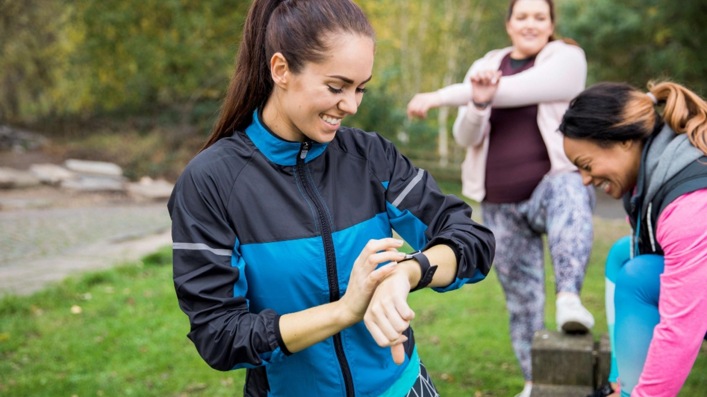 A group of women getting ready to run in the park