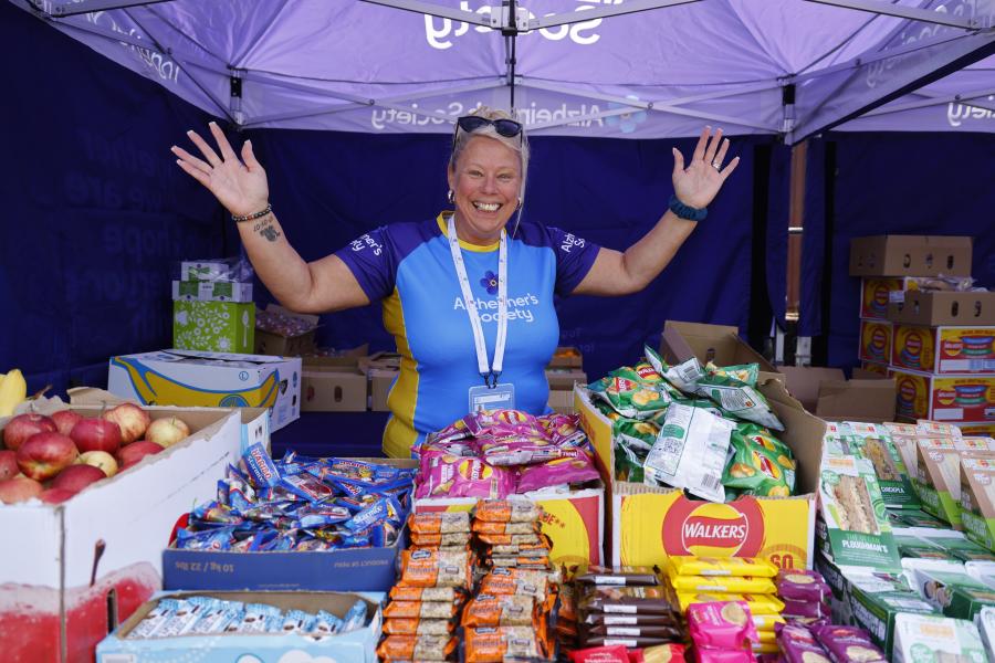 Lady smiling in front of snacks in a tent