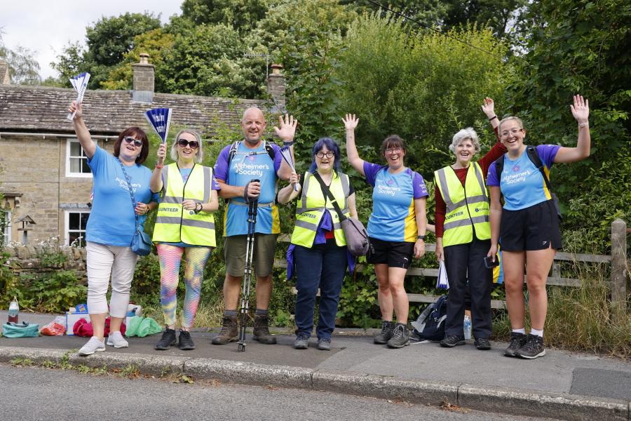 Group of volunteers on the Trek26 route cheering.