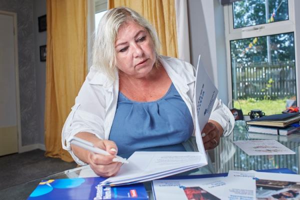 woman sat at the table looking at pamphlets