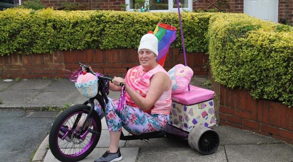 Woman named joy riding a bike dressed up as a cupcake 