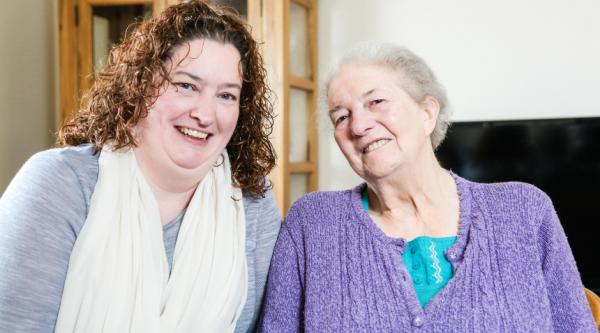 A carer smiling with a person with dementia