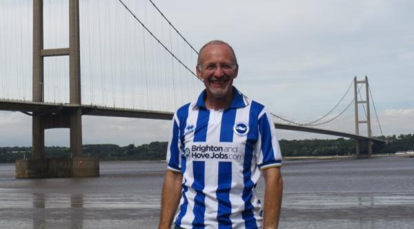 David in front of the Humber bridge, wearing a Brighton shirt