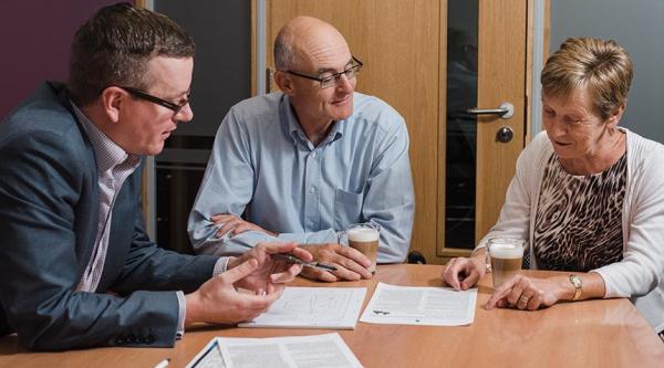 People looking at legal documents with a solicitor