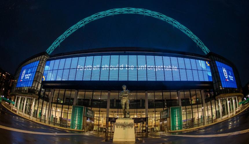 Wembley stadium lit up with the words 'football should be unforgettable'