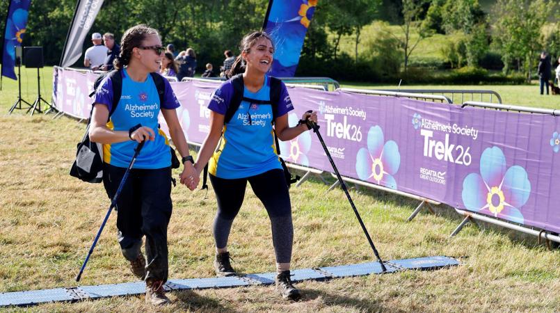 Two trekkers crossing the finish line