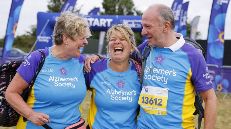 3 people smiling at the start line of Trek26 Suffolk Coast