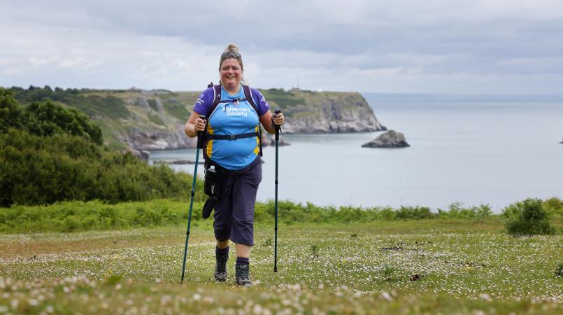 Person trekking along coastline