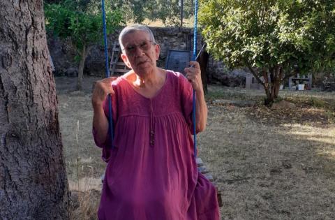 Lucas' grandma, sat on a swing below a tree