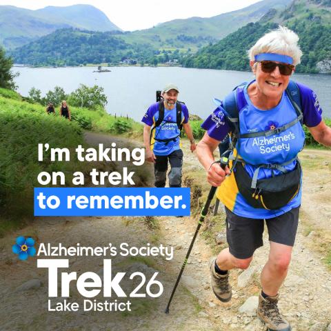 Two trekkers trekking through the Lake District with the text 'I'm taking on a trek to remember'