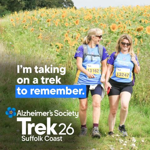 Two females trekking through a sunflower field with the text 'I'm taking on a trek to remember'