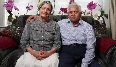 A husband and wife sat in their living room.