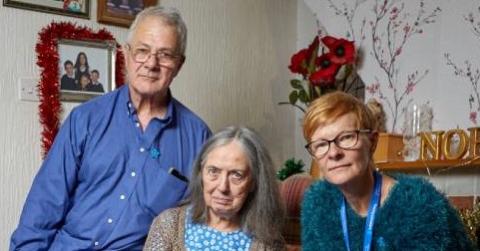 A family sit together in a festive room